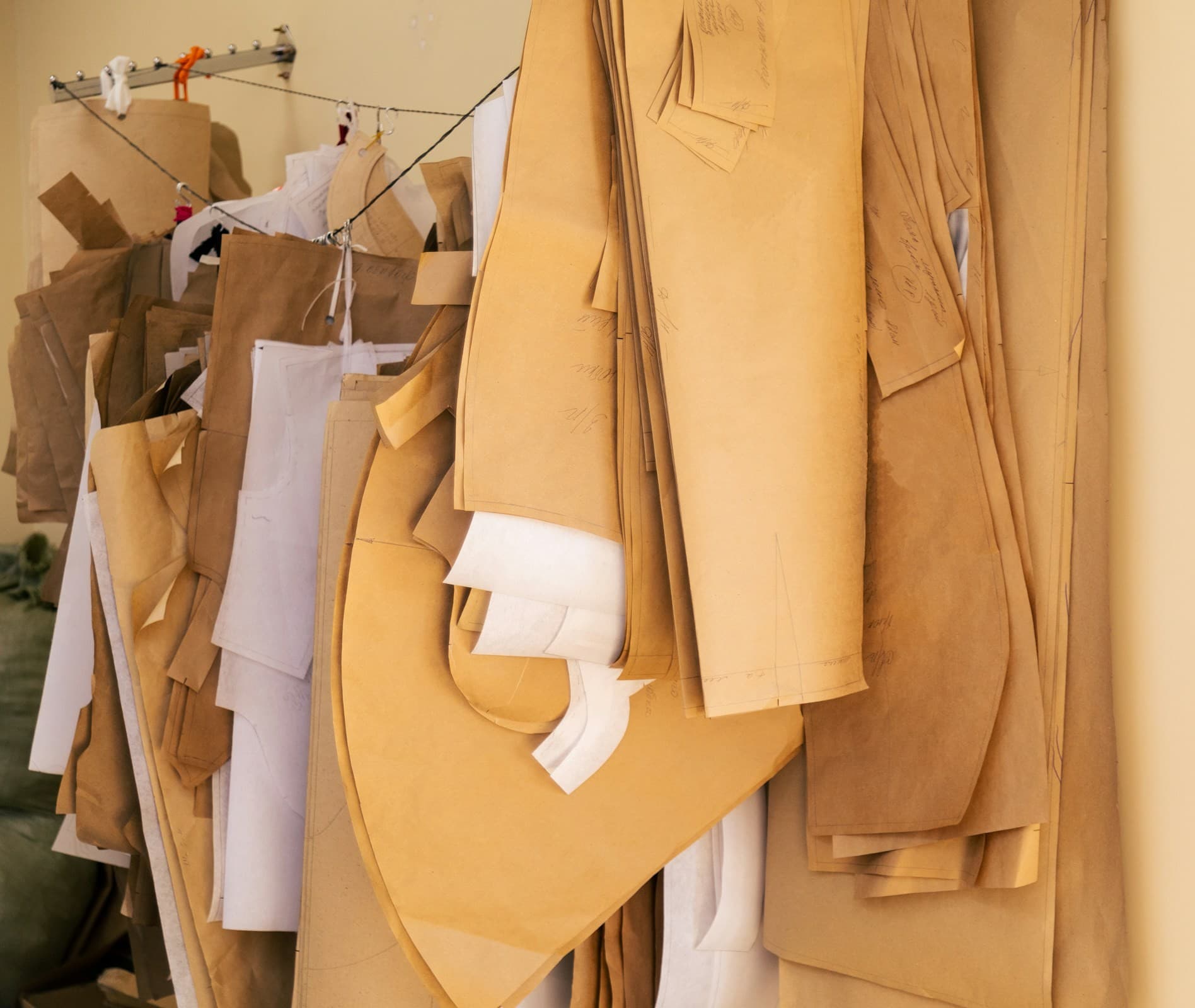 Cardboard patterns hanging in a row.